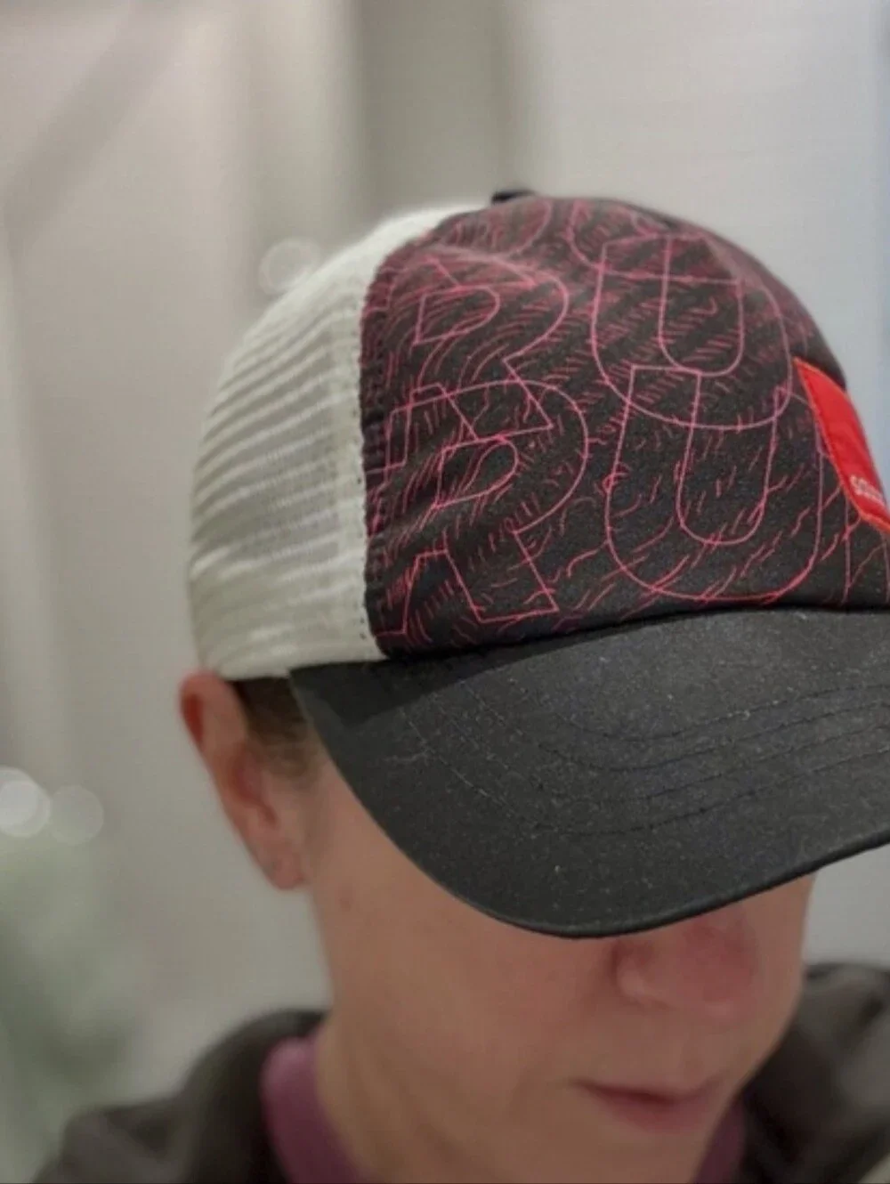 Saucony Black Running Hat with Red Patch and Pink Graphic Lines